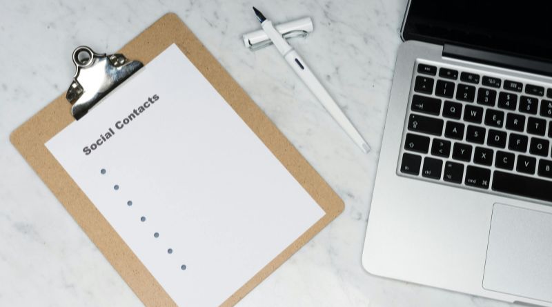 A clipboard with a notepad and pen placed on a desk, symbolizing collaboration and
knowledge sharing functions.